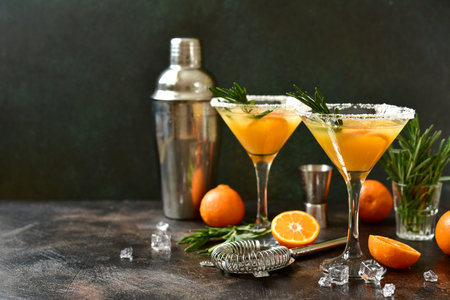 Tangerine cocktail with rosemary on a dark slate, stone or concrete background.の写真素材