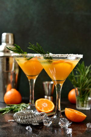 Tangerine cocktail with rosemary on a dark slate, stone or concrete background.の写真素材