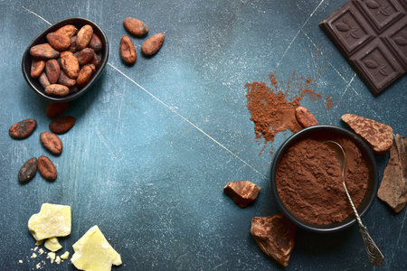 Ingredients for making homemade chocolate on a blue slate, stone or concrete table. Top view with copy space.の写真素材