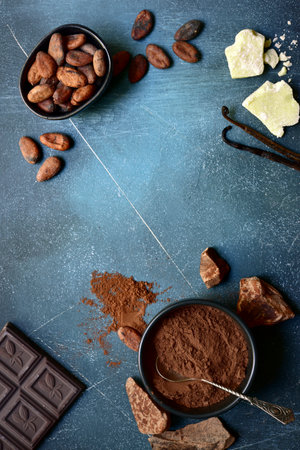 Ingredients for making homemade chocolate on a blue slate, stone or concrete table. Top view with copy space.の写真素材