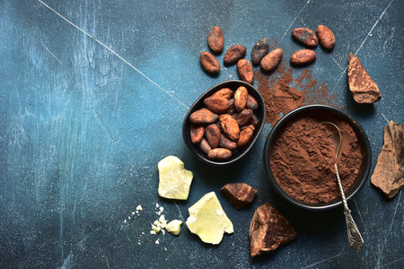Ingredients for making homemade chocolate on a blue slate, stone or concrete table. Top view with copy space.の写真素材