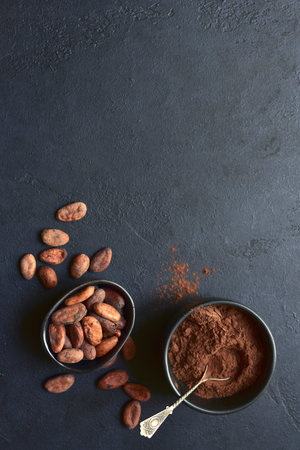 Ingredients for making homemade chocolate on a blue slate, stone or concrete table. Top view with copy space.の写真素材