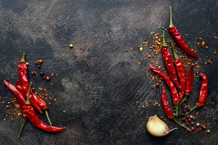 Chili pepper and garlic on a dark slate, stone or concrete background. Top view with copy space.の写真素材