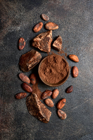 Ingredients for making homemade chocolate on a dark slate, stone or concrete table. Top view with copy space.の写真素材