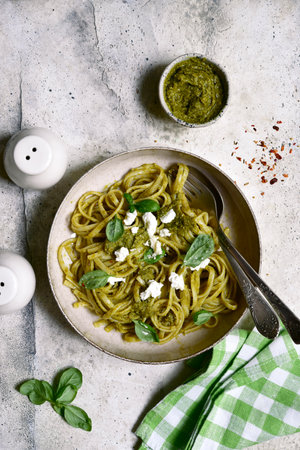 Pasta with pesto sauce, traditional dish of Italian cuisine on a light gray slate, stone or concrete background. Top view with copy space.の写真素材