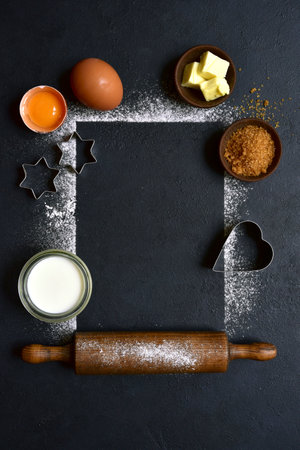 Food background with ingredients for baking on a black slate, stone or concrete table. Top view with copy space.の写真素材