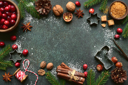 Christmas baking background with ingredients for making cake or biscuit on a dark green slate, stone or concrete table. Top view with copy space.の写真素材