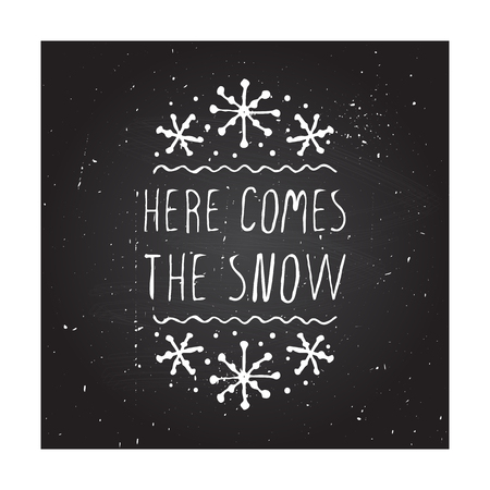 Christmas greeting card with text on chalkboard background. Here comes the snow. Chalkboard typographic with text and snowflakes. illustration for seasonal winter design. christmas badge.のイラスト素材