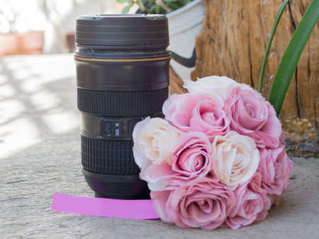 bouquet of pink roses and camera lensの写真素材