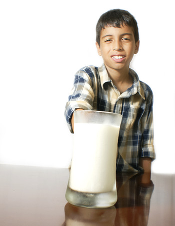 kid with a glass of milkの写真素材