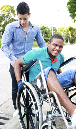 young man in a wheelchair outsideの写真素材