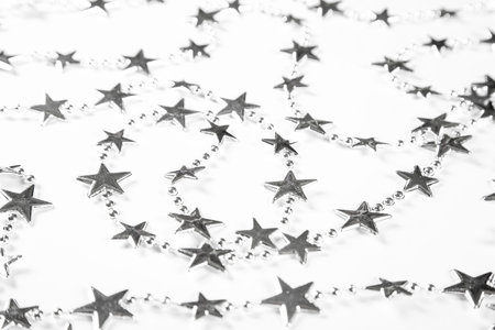 Christmas background with silver stars decorations on white. Simple Christmas composition with copy...
