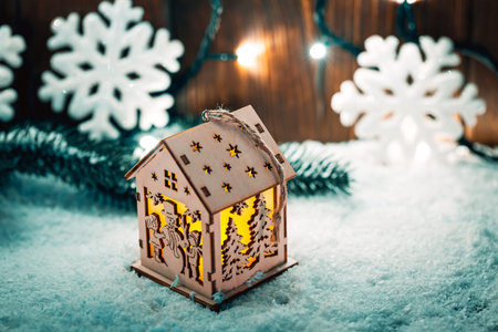 Christmas candle lantern and Christmas tree branches, snow, snowflake and decorations on bokeh background blurred lights. Free spaceの写真素材