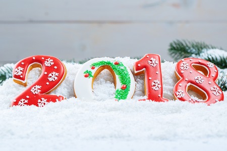Christmas background with gingerbread cookie 2018, snow and branches of a Christmas tree. Free spaceの写真素材
