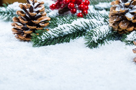 Christmas and New Year background with Christmas candle and Christmas tree branches on snow and decorations. Free spaceの写真素材