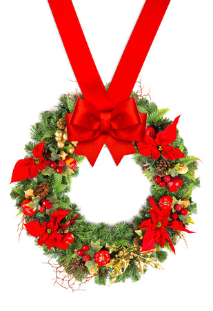 christmas wreath with poinsettia flowers, golden decoration and red ribbon bow isolated on white backgroundの写真素材