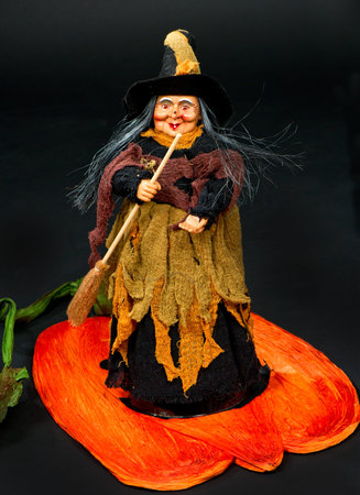 halloween witch with a broom on black backgriund