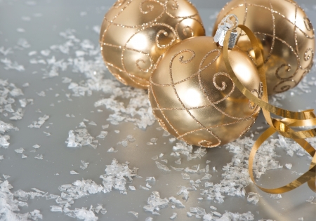 golden shiny christmas balls with snow decorationの写真素材