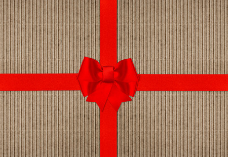 red ribbon bow on cardboard paper texture with text DO NOT OPEN UNTIL CHRISTMASの写真素材