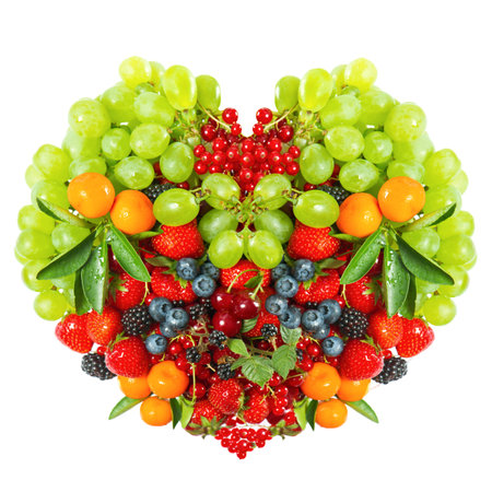 heart shaped mix of fruits and berries isolated on white 