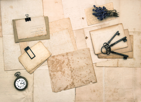 old letters and photos, vintage accessories, keys, clock, flowers  nostalgic sentimental paper backgroundの写真素材