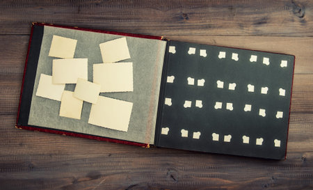 antique album with old photos on wooden table  vintage style background