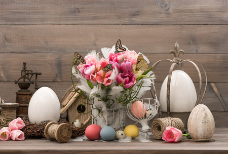 Easter decoration with pink tulips and colored eggsの写真素材
