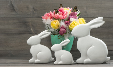 Easter bunnies with tulips flowers. Retro style toned picture