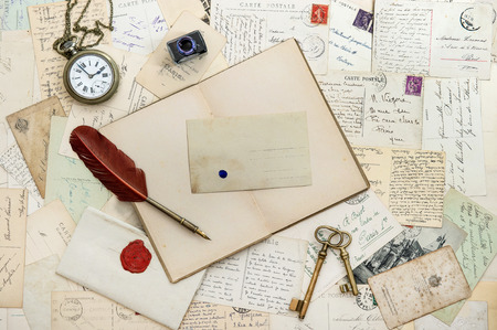 open notebook, old writing accessories and postcards  romantic sentimental vintage backgroundの写真素材