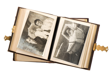 open antique album with baby photos isolated on white background  vintage nostalgic pictureの写真素材