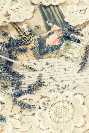 vintage ink pen, key, perfume, lavender flowers and old love letters. retro style toned pictureの写真素材