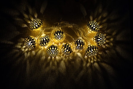 Glowing golden lights garland on dark background