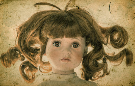 Antique doll. Vintage toy. Retro style toned picture with grange textureの写真素材