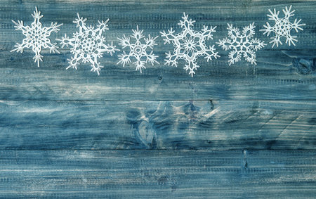 snowflakes border over rustic wooden background. festive winter holidays decorationの写真素材