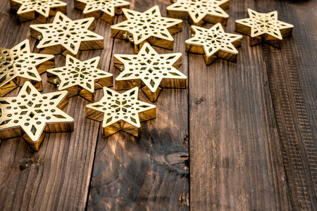 christmas decoration snowflakes and on rustic wooden background. festive golden ornamentの写真素材