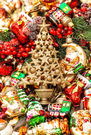 golden christmas tree with baubles, toys and colorful ornamentsの写真素材