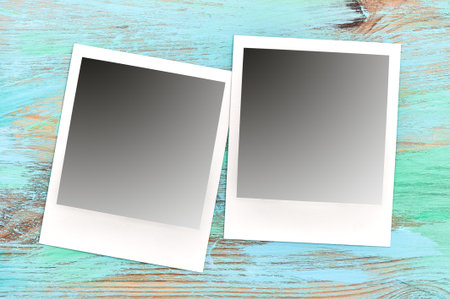 Retro style photo frames on rustic wooden background. Scratched table textureの写真素材