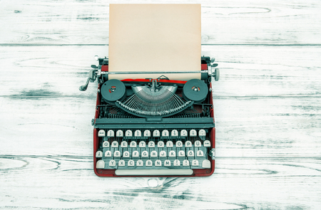 Antique typewriter on wooden table. Vintage style colored picture. German letteringの写真素材