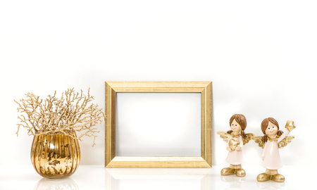 Golden frame and Christmas decorations Angel. Mock up with space for your picture or textの写真素材