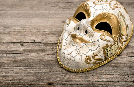 Carnival mask harlequin on rustic wooden background. Mardi gras. Holidays backgroundの写真素材