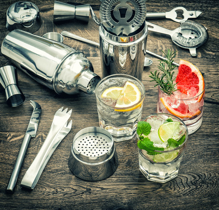 Drinks with ice and tonic water. Cocktail making accessories. Vintage style toned pictureの写真素材