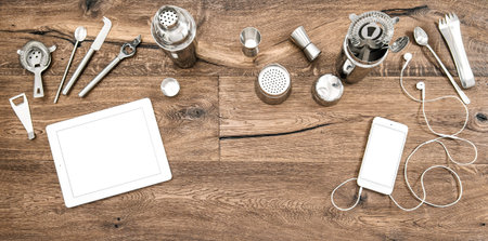 Bar counter with tools, accessories and electronic devices. Flat lay background