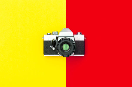 Vintage camera on stylish color yellow red background. Minimal conceptの写真素材