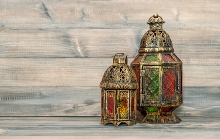 Oriental vintage light lantern. Arabic holidays decoration on wooden backgroundの写真素材