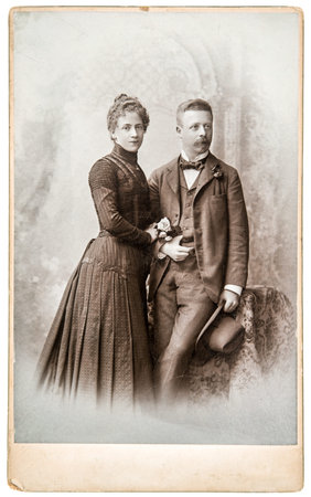 Antique family portrait man and woman wearing vintage clothing in 1880