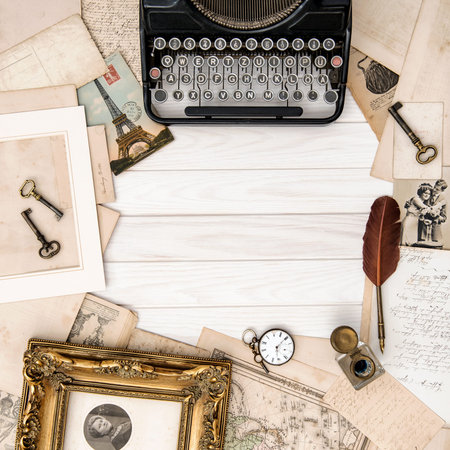 Antique typewriter and vintage office tools on wooden table. Flat lay