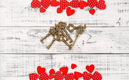 Red hearts golden keys on white wooden background. Valentines Day Loveの写真素材
