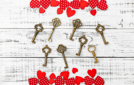 Red hearts golden keys on white wooden background. Valentines Day Loveの写真素材