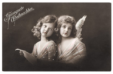 Angel girls with white wings. Christmas greetings card. Vintage picture with original film grain and...