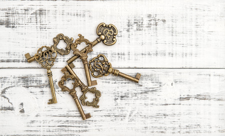 Antique keys on rustic wooden background. Nostalgic still lifeの写真素材